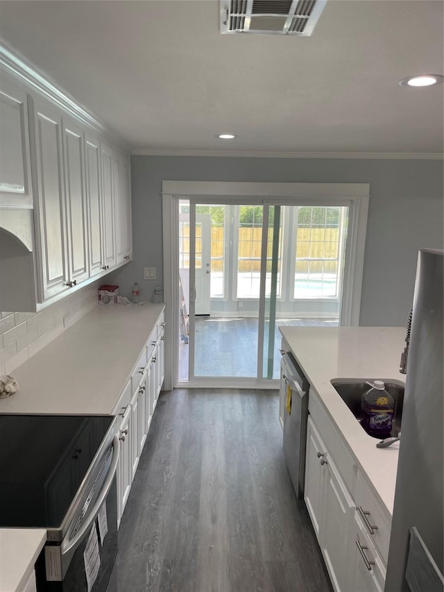 kitchen with ornamental molding, black electric range, visible vents, dark wood finished floors, and stainless steel dishwasher