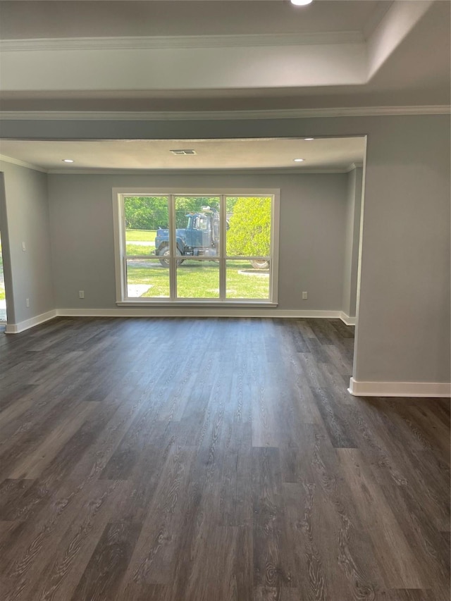 spare room with ornamental molding, baseboards, and dark wood-style floors
