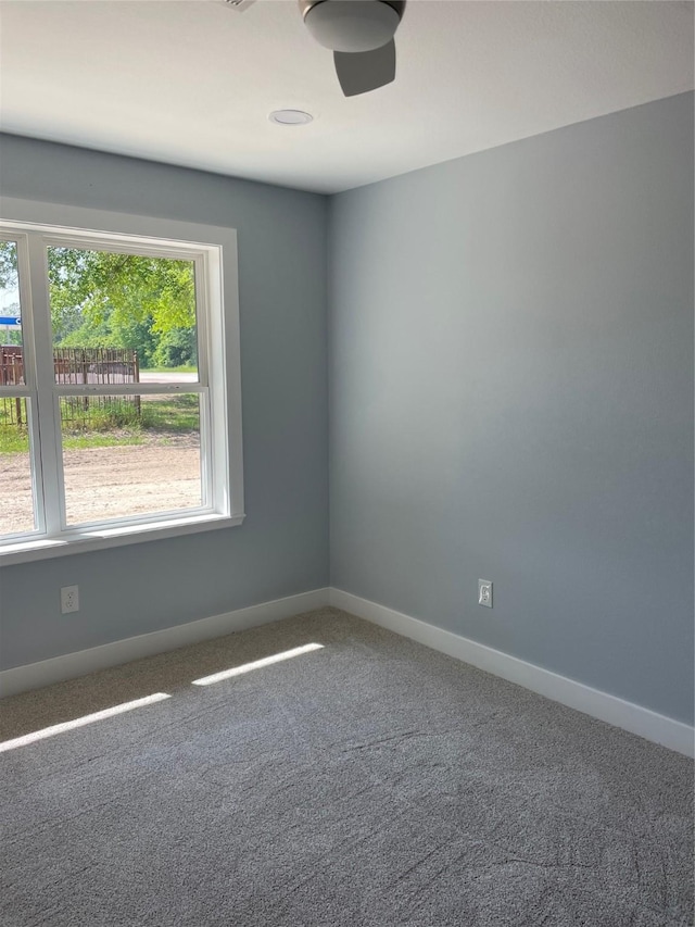 spare room with carpet flooring and baseboards