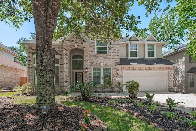 70 N Altwood Cir, The Woodlands, TX 77382 - traditional home featuring driveway, brick siding, a garage, and stucco siding