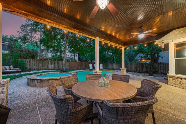 70 N Altwood Cir, The Woodlands, TX 77382 - fenced backyard with a ceiling fan, a patio area, a pool with connected hot tub, and outdoor dining space