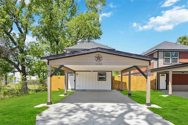 view of front of house with a front yard, fence, a shingled roof, and driveway