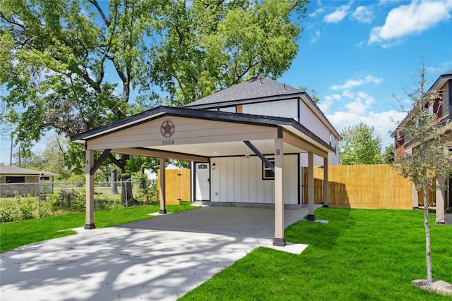 bungalow featuring a carport, a front yard, fence, and driveway