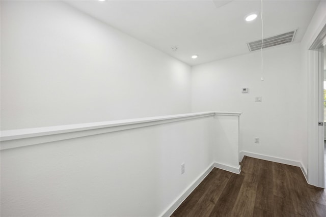 interior space with recessed lighting, visible vents, attic access, and dark wood-style floors