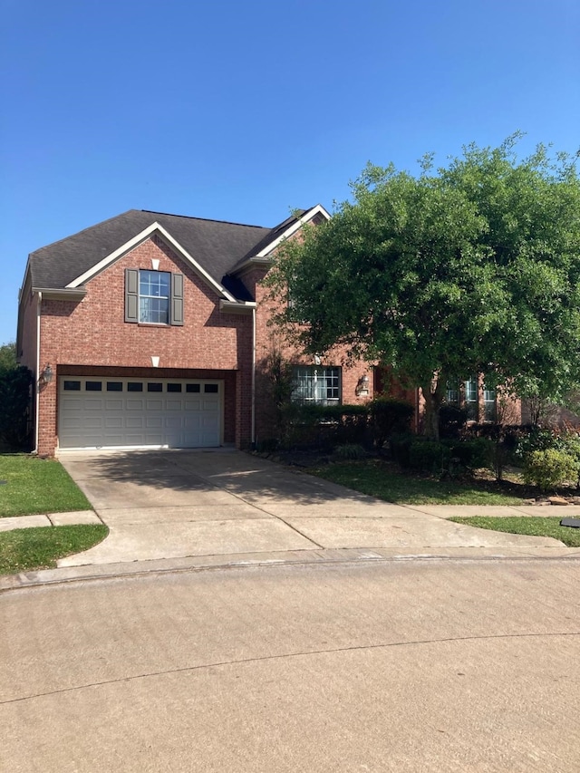 view of front of property with concrete driveway, brick siding, and an attached garage