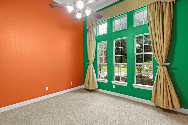 empty room with baseboards, carpet, and ceiling fan