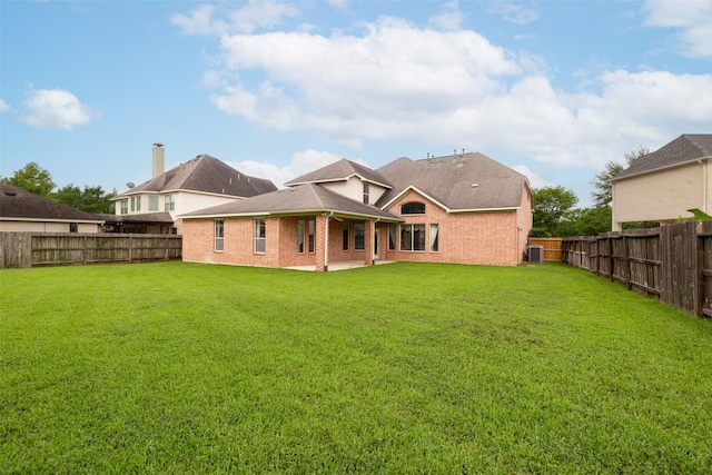 rear view of house featuring a gazebo, a fenced backyard, a lawn, and central air condition unit