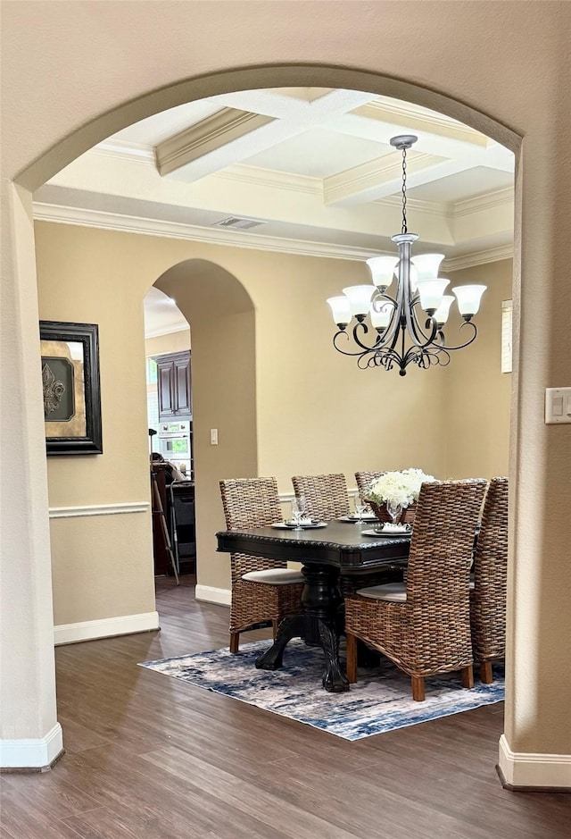 34315 E Short Leaf Pine Ct, Pinehurst, TX 77362 - dining area featuring arched walkways, ornamental molding, a chandelier, and dark wood-style floors
