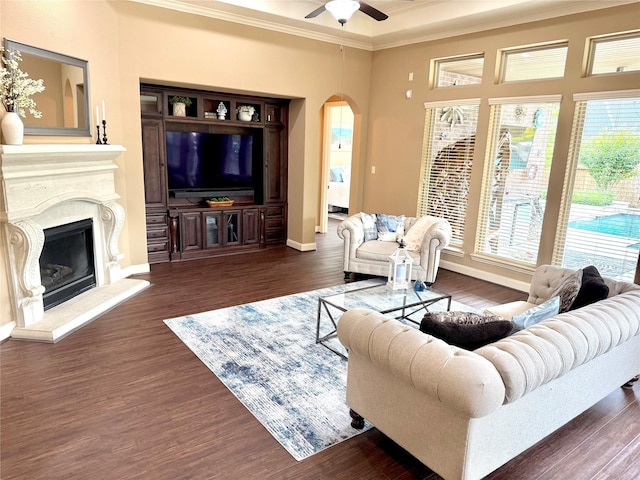 34315 E Short Leaf Pine Ct, Pinehurst, TX 77362 - living area featuring wood finished floors, a ceiling fan, crown molding, arched walkways, and a high end fireplace