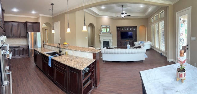 34315 E Short Leaf Pine Ct, Pinehurst, TX 77362 - kitchen featuring freestanding refrigerator, a ceiling fan, dark wood finished floors, open floor plan, and arched walkways