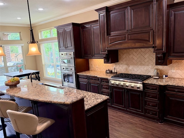 34315 E Short Leaf Pine Ct, Pinehurst, TX 77362 - kitchen featuring a breakfast bar, light stone counters, decorative backsplash, dark wood-style floors, and appliances with stainless steel finishes