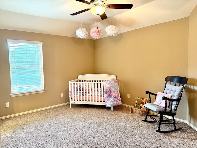 34315 E Short Leaf Pine Ct, Pinehurst, TX 77362 - bedroom with a crib, baseboards, ceiling fan, and carpet floors