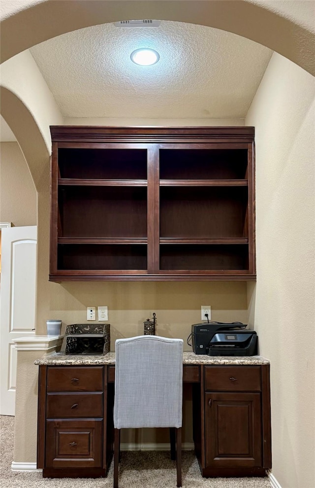 34315 E Short Leaf Pine Ct, Pinehurst, TX 77362 - office featuring built in study area, light colored carpet, a textured ceiling, arched walkways, and baseboards