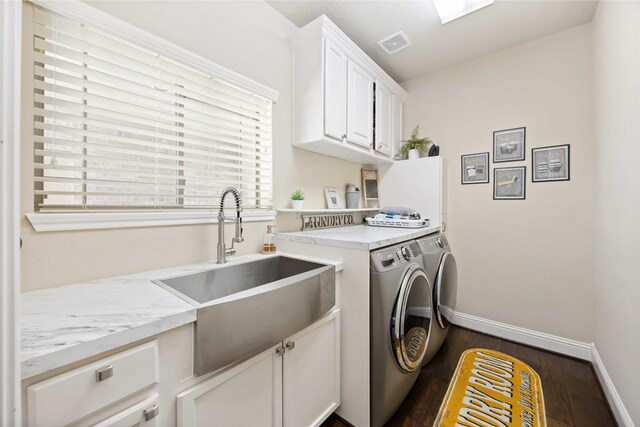 21207 Fairhaven Creek Dr, Cypress, TX 77433 - laundry room with dark wood finished floors, visible vents, a sink, separate washer and dryer, and cabinet space
