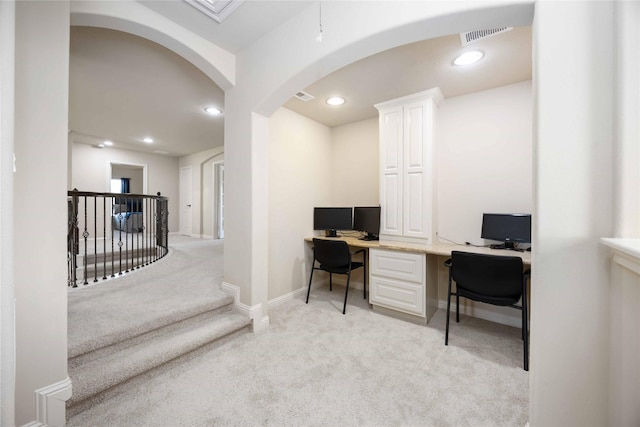 21207 Fairhaven Creek Dr, Cypress, TX 77433 - home office featuring light carpet, arched walkways, baseboards, visible vents, and recessed lighting