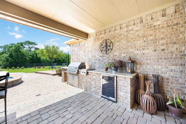 21207 Fairhaven Creek Dr, Cypress, TX 77433 - view of patio / terrace with area for grilling, a fenced backyard, beverage cooler, and exterior kitchen