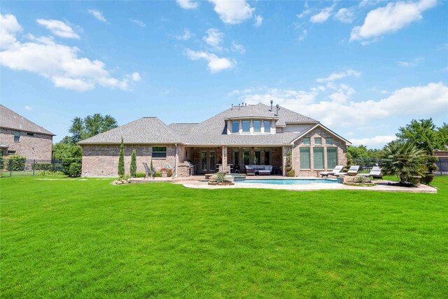 21207 Fairhaven Creek Dr, Cypress, TX 77433 - rear view of house with a yard, brick siding, a patio area, and an outdoor hangout area