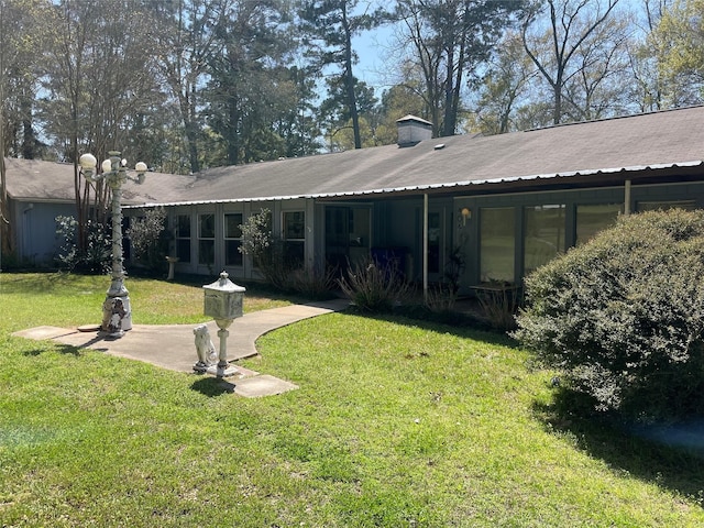 404 N Grace St, Crockett, TX 75835 - back of house with a lawn and a chimney