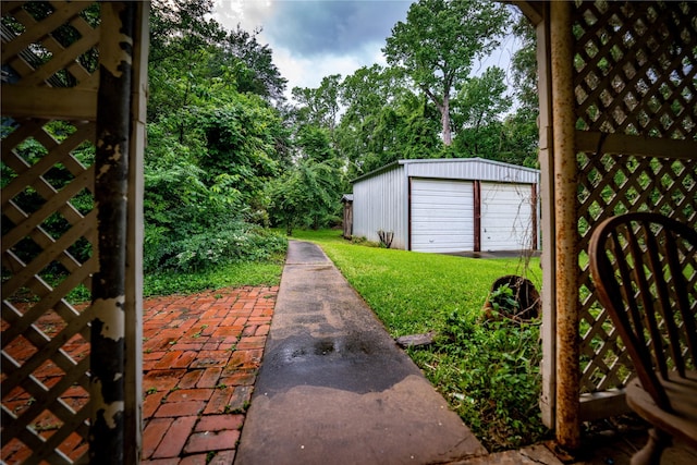 404 N Grace St, Crockett, TX 75835 - view of green lawn featuring a detached garage and an outbuilding