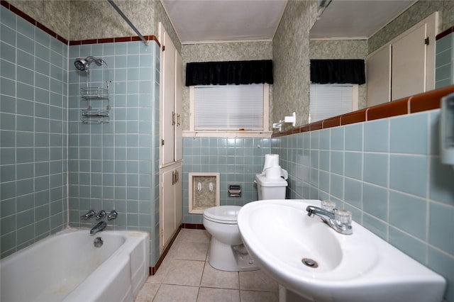 full bathroom featuring toilet, tile walls, tile patterned floors, and  shower combination