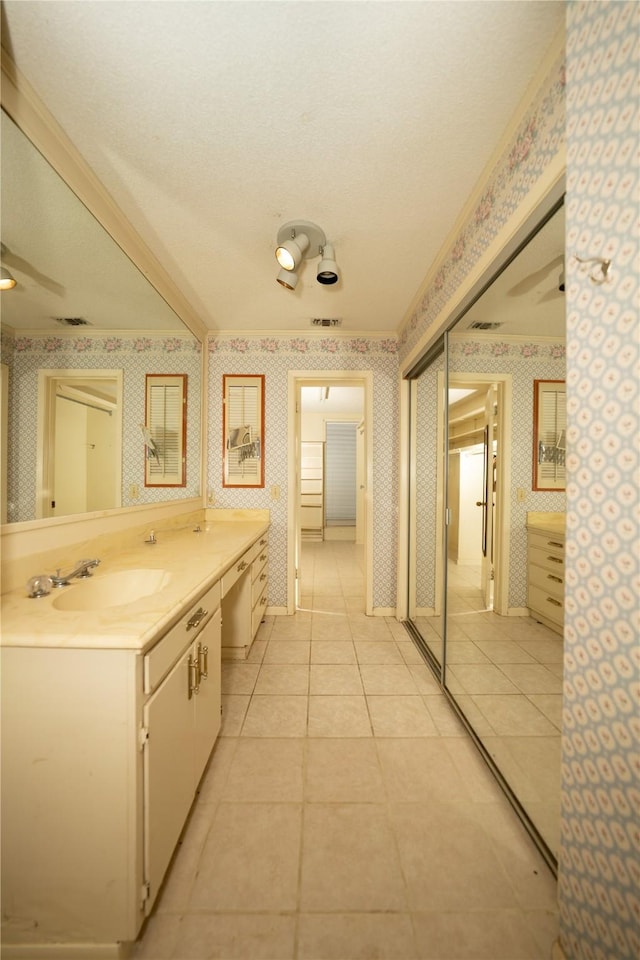 404 N Grace St, Crockett, TX 75835 - bathroom with wallpapered walls, vanity, tile patterned floors, and a textured ceiling