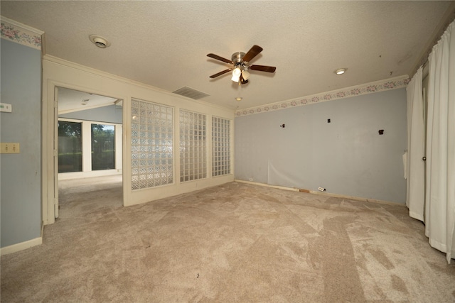 404 N Grace St, Crockett, TX 75835 - carpeted spare room with ceiling fan, crown molding, and a textured ceiling