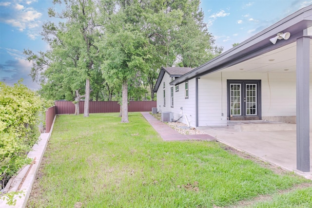 1189 Fm 935, Lott, TX 76656 - view of yard with central air condition unit, a patio, french doors, and a fenced backyard