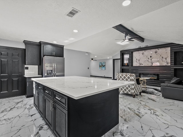 11506 Kirkhollow Dr, Houston, TX 77089 - kitchen featuring stainless steel fridge with ice dispenser, dark cabinetry, open floor plan, light marble finish flooring, and recessed lighting