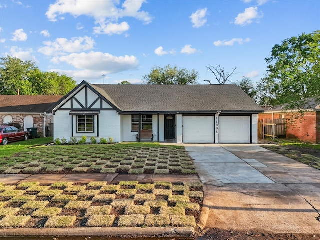 11506 Kirkhollow Dr, Houston, TX 77089 - tudor house featuring concrete driveway, an attached garage, and brick siding