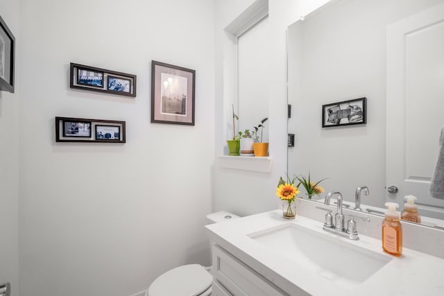 bathroom with toilet and vanity