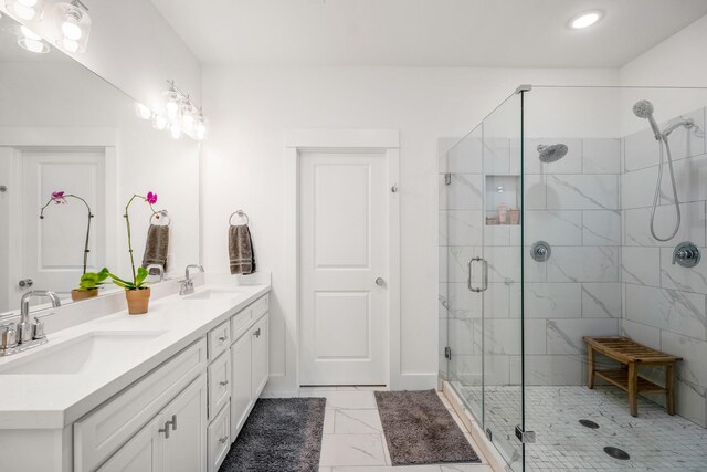 bathroom featuring a sink, double vanity, and a stall shower