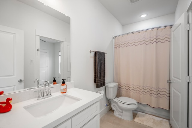 full bathroom featuring toilet, visible vents, recessed lighting, wood finished floors, and vanity