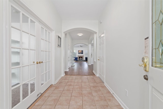 8122 Dune Brook Dr, Pearland, TX 77089 - corridor with french doors, arched walkways, and light tile patterned flooring