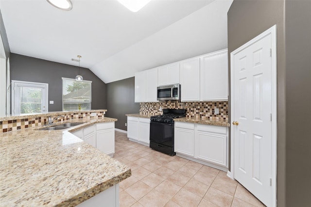 8122 Dune Brook Dr, Pearland, TX 77089 - kitchen with stainless steel microwave, black range with gas stovetop, a sink, decorative backsplash, and lofted ceiling