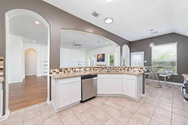 8122 Dune Brook Dr, Pearland, TX 77089 - kitchen featuring dishwasher, arched walkways, a ceiling fan, lofted ceiling, and tasteful backsplash