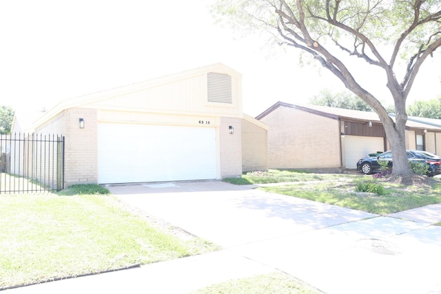 view of front of home featuring brick siding, an attached garage, fence, and concrete driveway