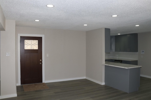 entrance foyer featuring baseboards, dark wood-style floors, recessed lighting, and a textured ceiling