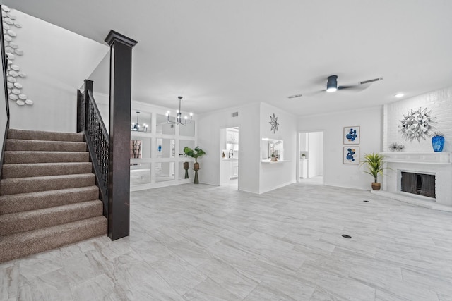 4731 N Cashel Cir, Houston, TX 77069 - unfurnished living room with ceiling fan with notable chandelier, ornamental molding, a large fireplace, visible vents, and stairway