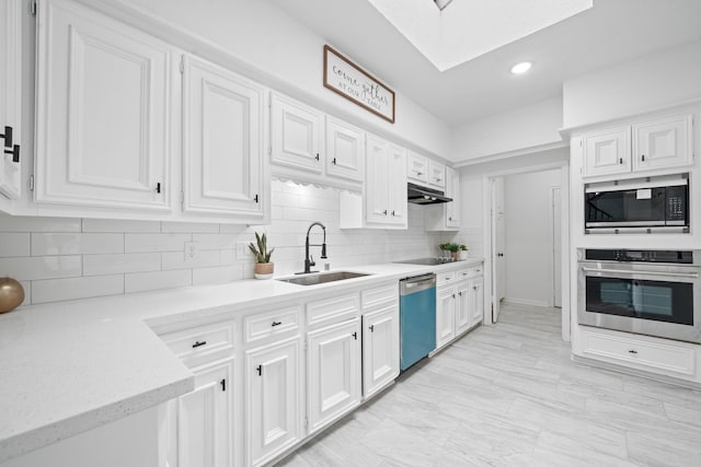 4731 N Cashel Cir, Houston, TX 77069 - kitchen featuring stainless steel oven, built in microwave, a skylight, dishwasher, and a sink