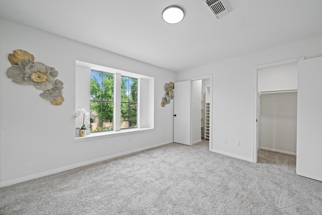 4731 N Cashel Cir, Houston, TX 77069 - unfurnished bedroom featuring a walk in closet, baseboards, visible vents, and carpet floors