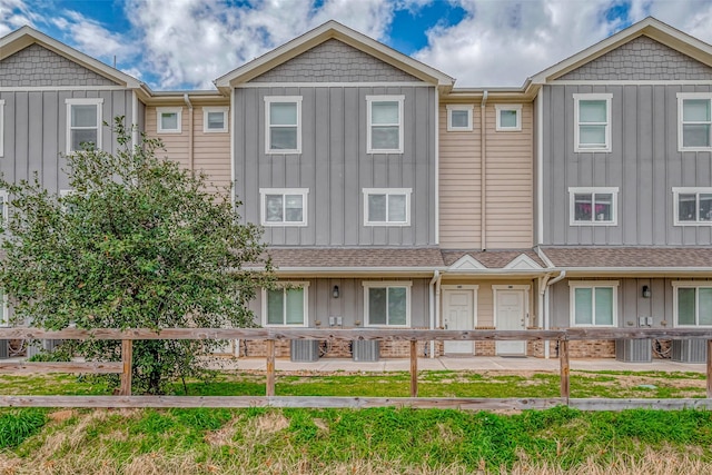 multi unit property featuring central AC unit and board and batten siding