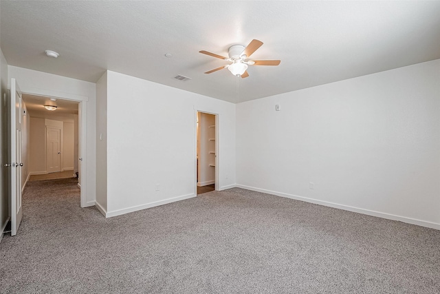 unfurnished room featuring visible vents, carpet flooring, ceiling fan, and baseboards