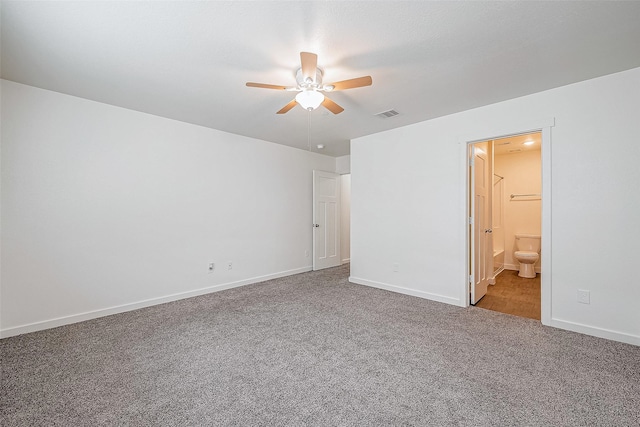unfurnished bedroom with ensuite bathroom, carpet, a ceiling fan, visible vents, and baseboards