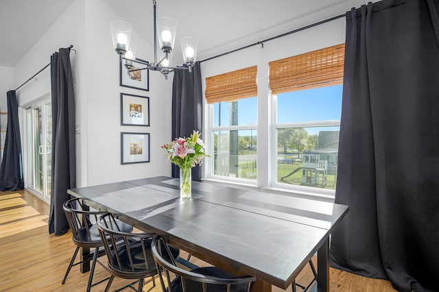 dining room with a chandelier and light wood-type flooring