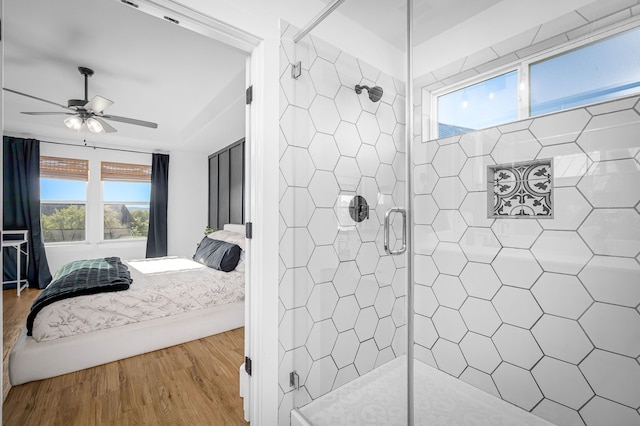 full bathroom featuring a shower stall, ensuite bathroom, ceiling fan, and wood finished floors