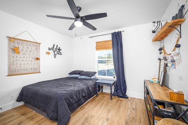 bedroom with baseboards, a ceiling fan, and wood finished floors