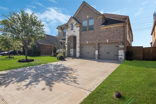 2736 Ahnya Ln, League City, TX 77573 - french country home featuring brick siding, concrete driveway, an attached garage, and stone siding