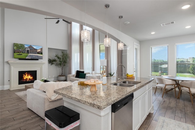 2736 Ahnya Ln, League City, TX 77573 - kitchen featuring a sink, dishwasher, open floor plan, white cabinets, and wood finished floors