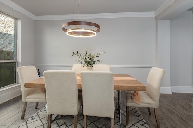 2736 Ahnya Ln, League City, TX 77573 - dining space featuring wood finished floors, ornamental molding, baseboards, and a chandelier