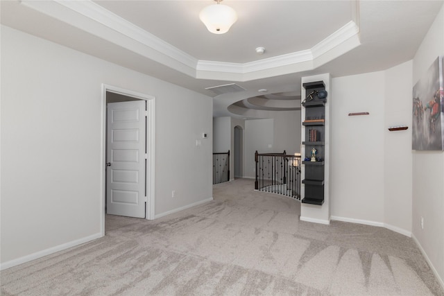 2736 Ahnya Ln, League City, TX 77573 - carpeted spare room featuring crown molding, a raised ceiling, baseboards, a smoke detector, and arched walkways